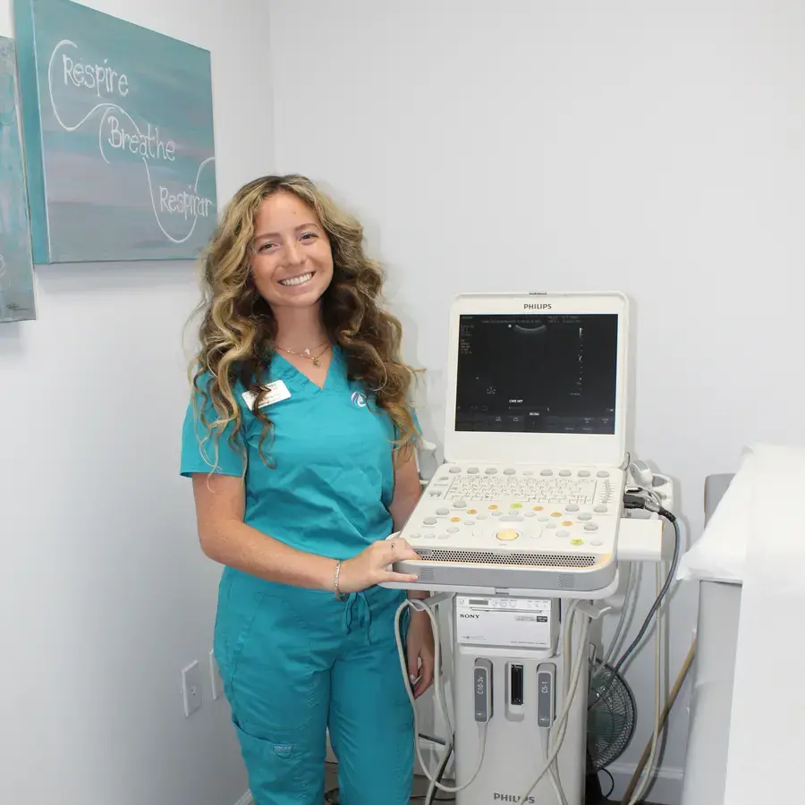 A Care Net sonographer beside the ultrasound machine